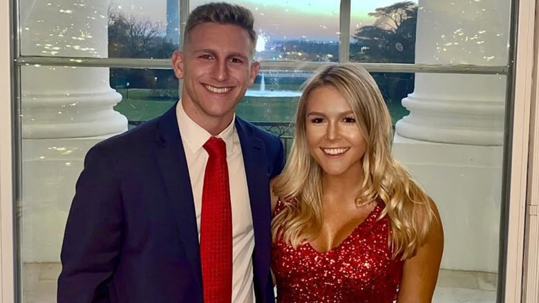 Karoline Leavitt posing in a red sparkly dress at the White House