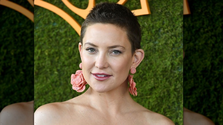 Kate Hudson with a brown pixie and pink earrings