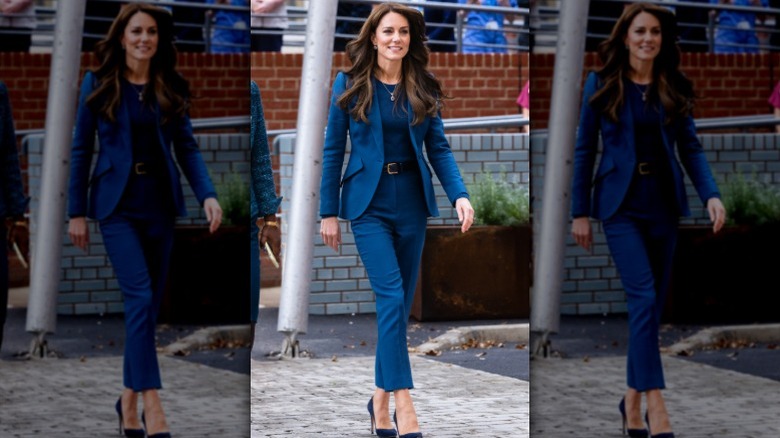 Kate Middleton walks wearing a blue suit