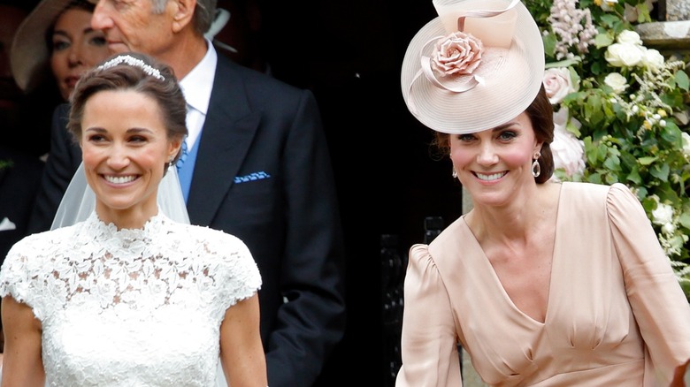 Pippa and Kate Middleton smile at Pippa's wedding