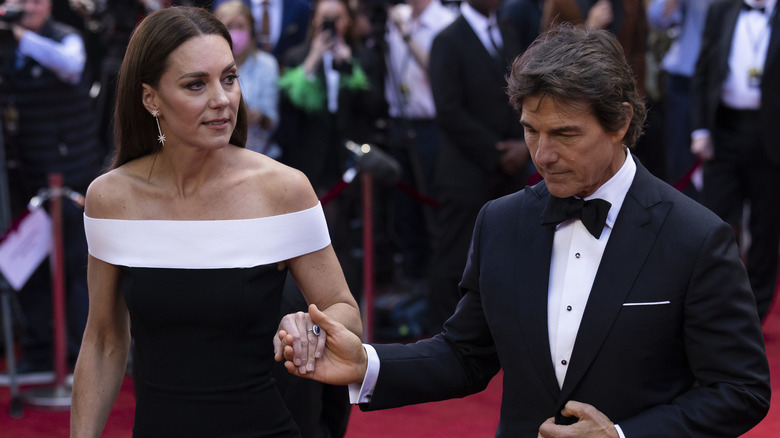 Kate Middleton holding Tom Cruise's hand