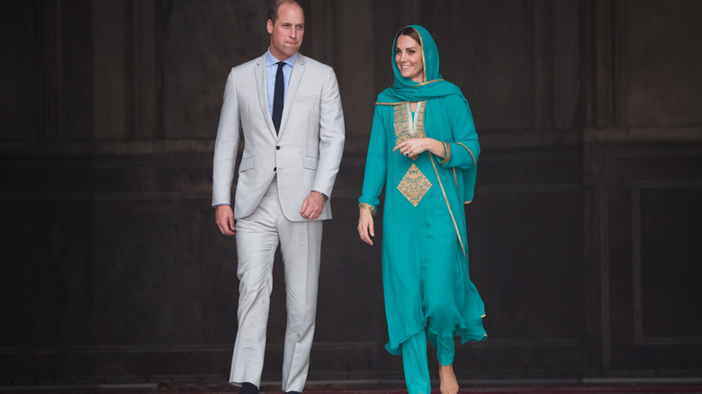 Kate Middleton in teal outfit smilinf