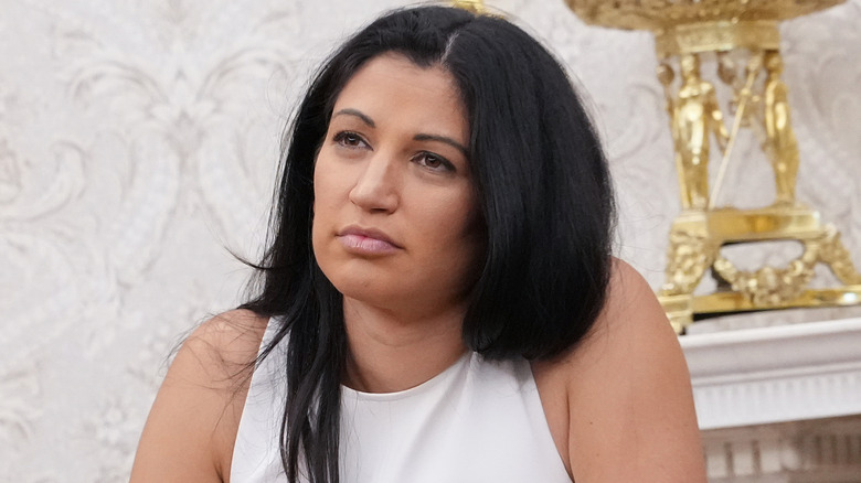 Katie Miller listens to a discussion in the White House