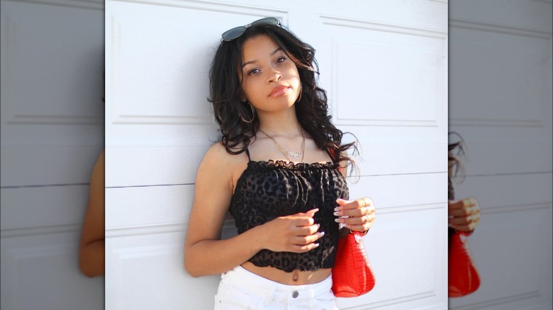 Girl carrying a scarlet handbag