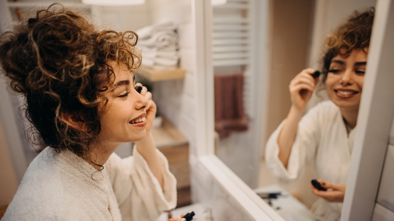 woman applying mascara