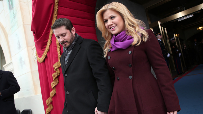 Brandon Blackstock and Kelly Clarkson holding hands