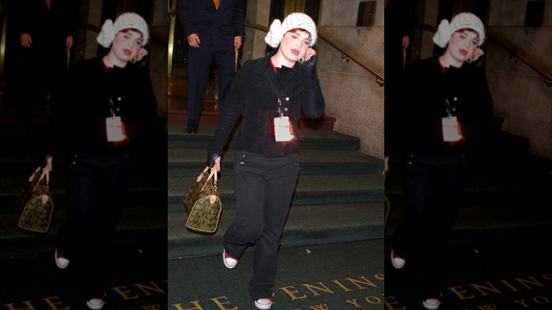 Kelly Osbourne, 17, the daughter of rocker Ozzy Osbourne, leaves a hotel with her family December 24, 2001 in New York City