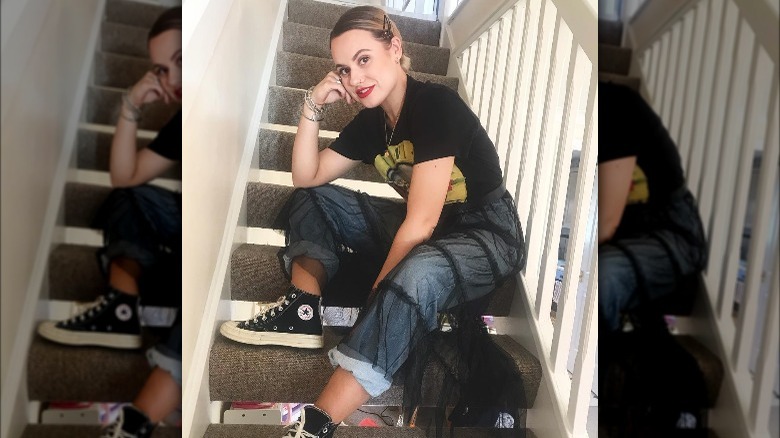 Girl wearing sheer skirt over jeans.