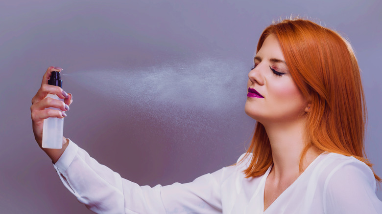 Woman applies setting spray