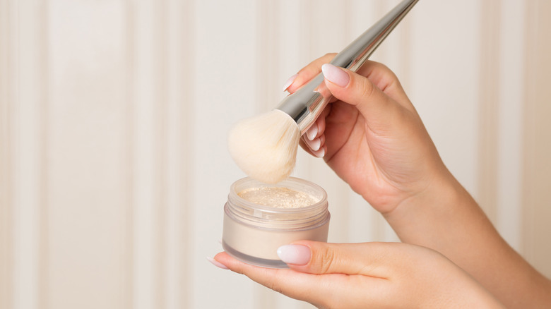 Woman holds setting powder