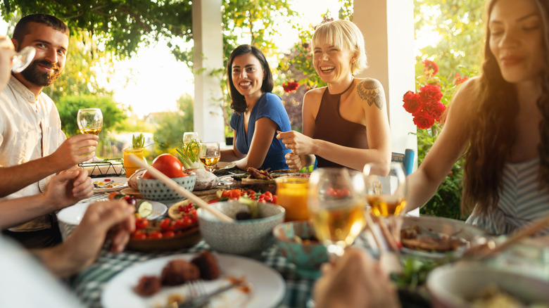 people sitting at table with food