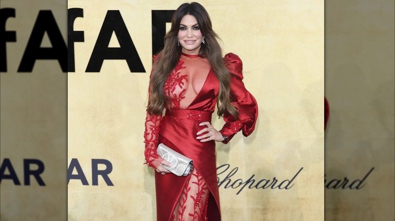 Kimberly Guilfoyle poses for a picture at the amfAR Gala in France wearing a revealing red dress