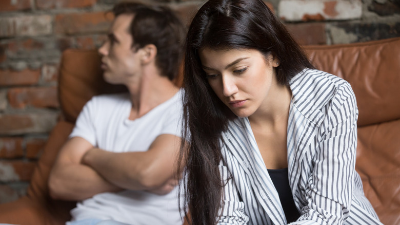 pensive woman next to man