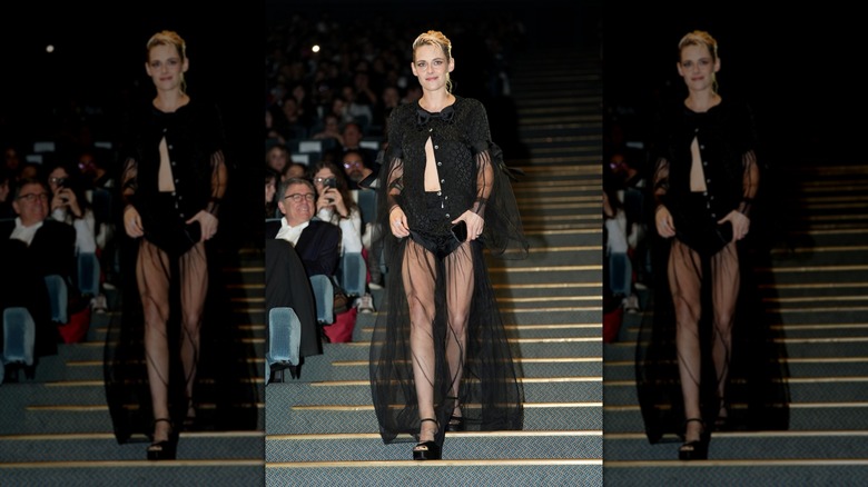 Kristen Stewart walking in a sheer black outfit