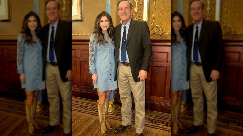 Kristi Noem poses for a photo wearing cowboy boots