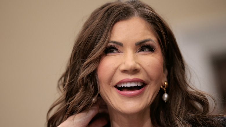 Kristi Noem smiling with a full glam makeup on