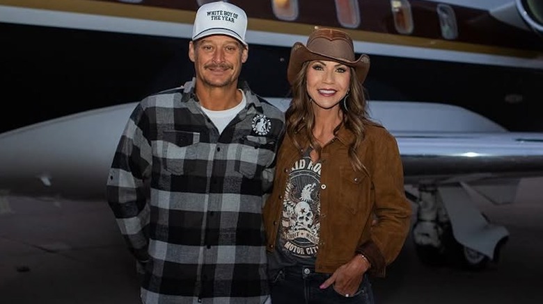 Kristi Noem wearing a cowboy hat while posing with Kid Rock