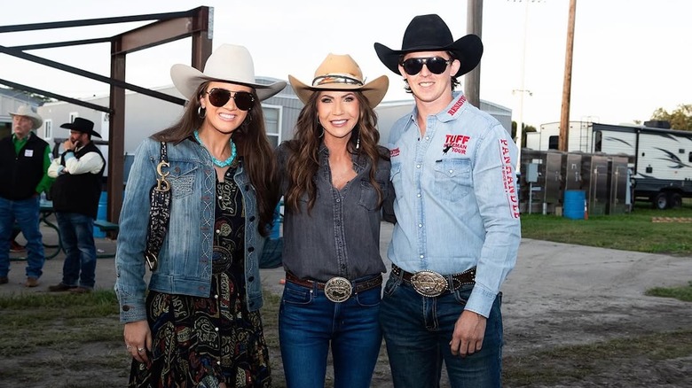 Kristi Noem and others posing with cowboy hats