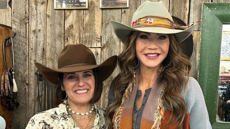 Kristi Noem and another woman posing with cowboy hats