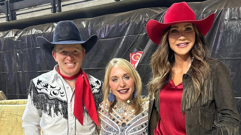 Kristi Noem posing with a red cowboy hat
