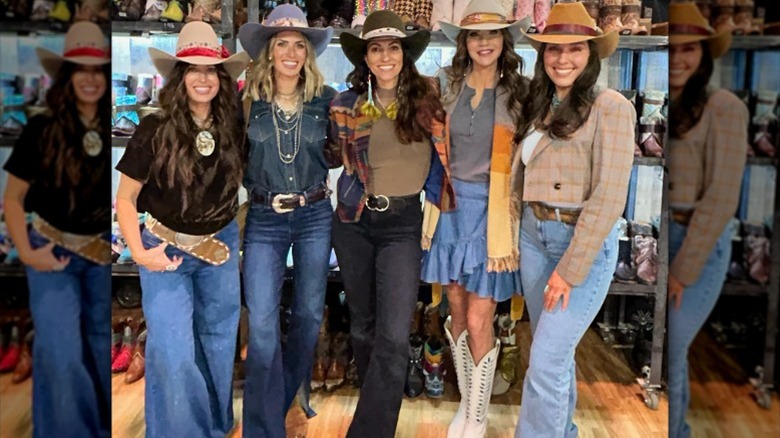 Kristi Noem poses with a group of women at a rodeo