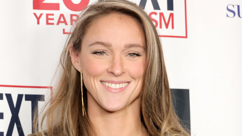 Kylie Kelce wearing gold dangly earrings