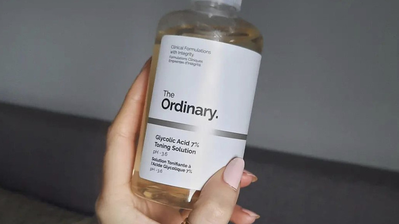 person holding glycolic acid 