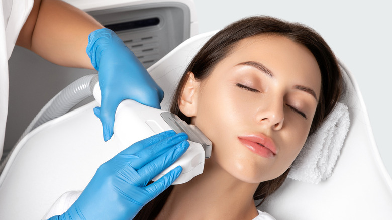 woman getting face lasered