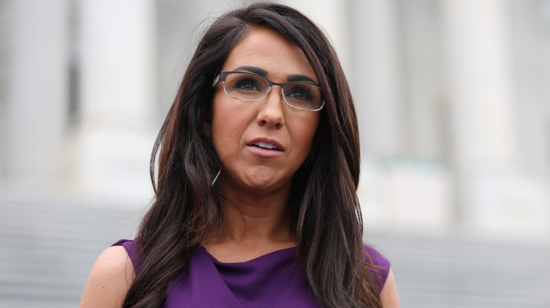 Lauren Boebert photographed wearing a purple dress and deep brunette hair