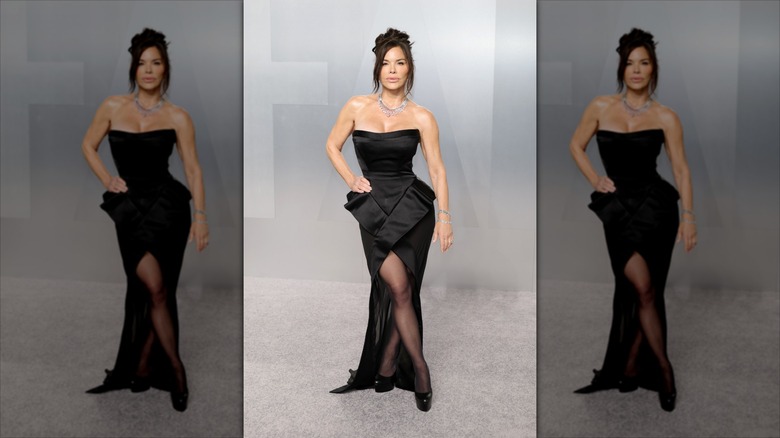 Lauren Sánchez Bezos poses wearing a crystal necklace and a black dress.