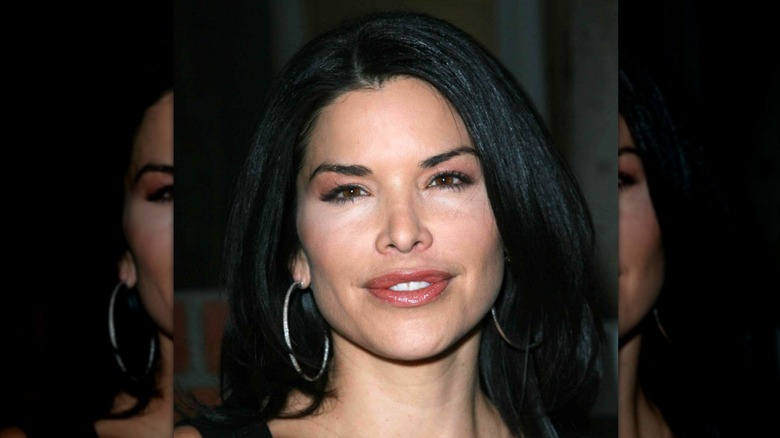 Lauren Sanchez with black hair and hoop earrings