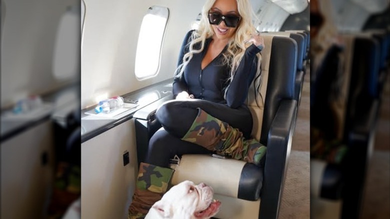 Bunnie Xo flying on a private plane with her dog