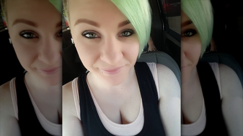 Woman wearing dark tank over a light tank