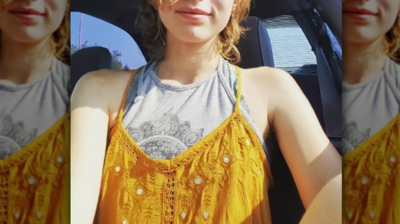 Woman wearing layered sleeveless tops