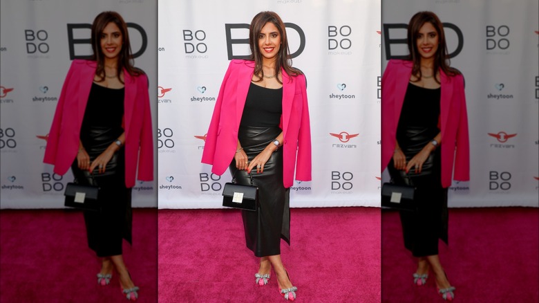 Woman with black skirt and pink jacket