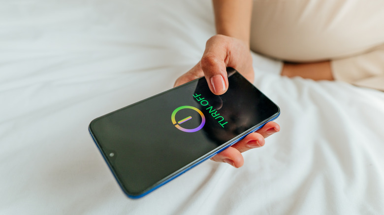 Person turning off phone