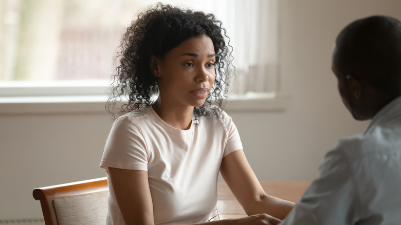 serious woman talking to man