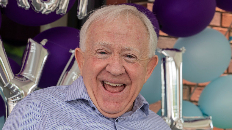 Leslie Jordan smiling in front of balloons