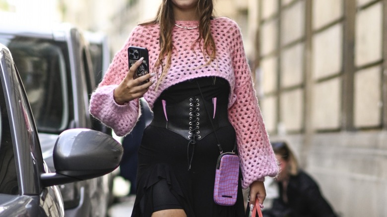 Woman wearing cropped knit sweater