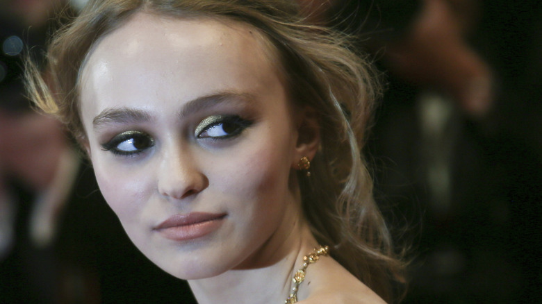 Lily-Rose Depp wearing smokey eye and gold eyeshadow