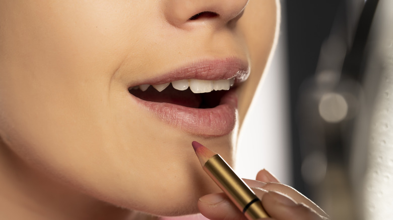 woman applying lip liner