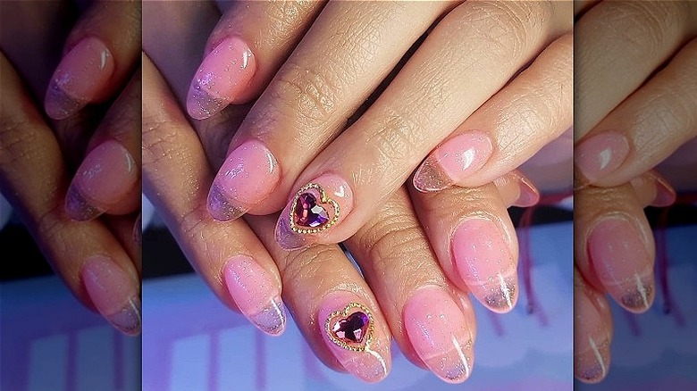 Sheer pink nails with sparse glitter 