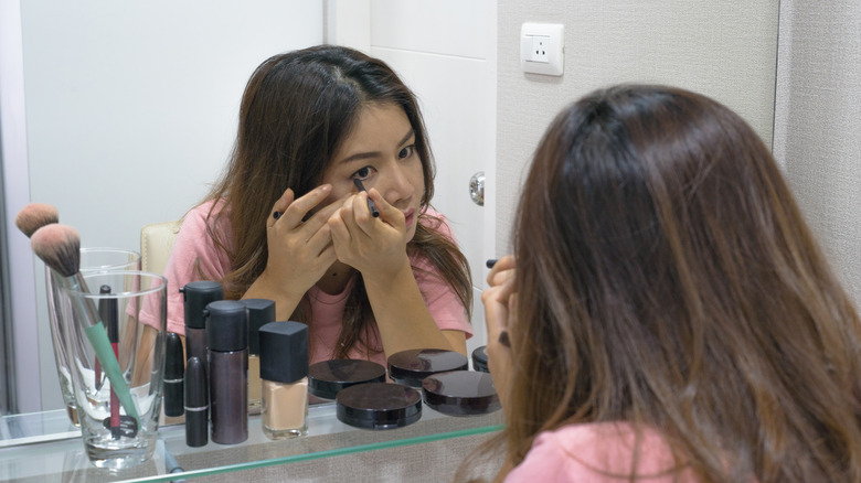 Woman applying eyeliner