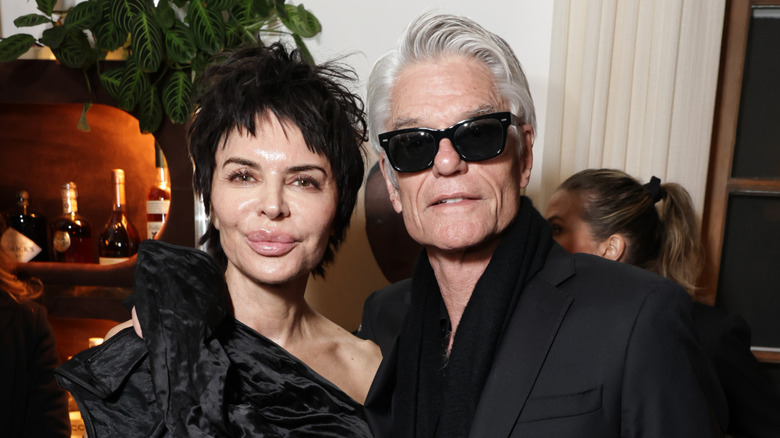 Lisa Rinna and Harry Hamlin posing in black outfits