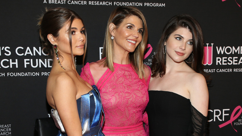 Lori Loughlin and her daughters Olivia Jade and Isabella Rose Giannulli at a red carpet event.