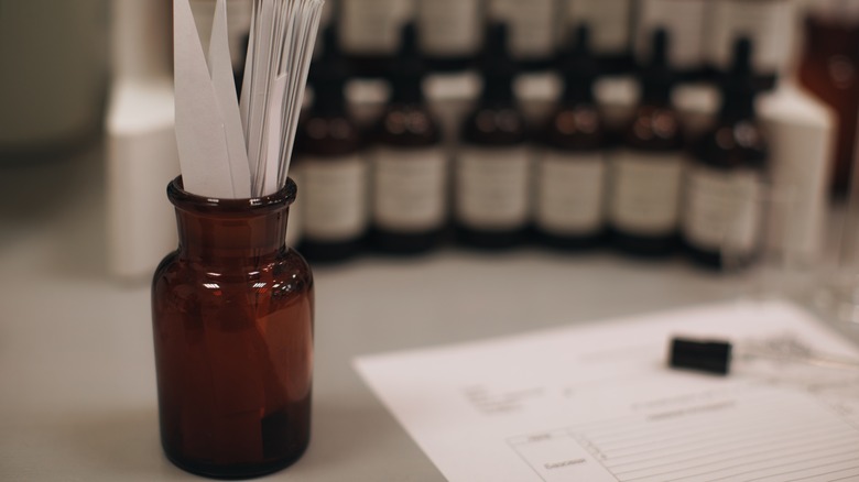 brown glass bottle with paper strips