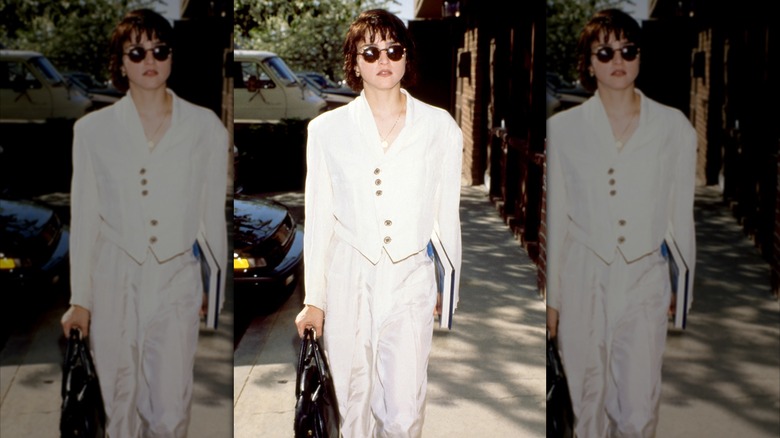 Madonna wearing a cropped white blazer and pants