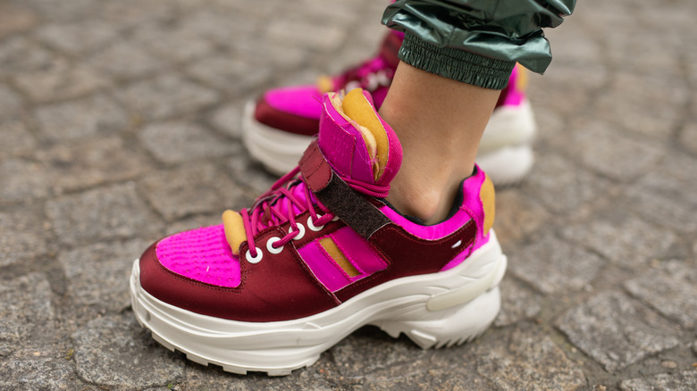 woman wearing magenta sneakers