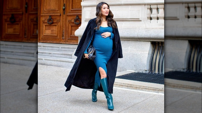 Woman wearing turquoise dress and boots