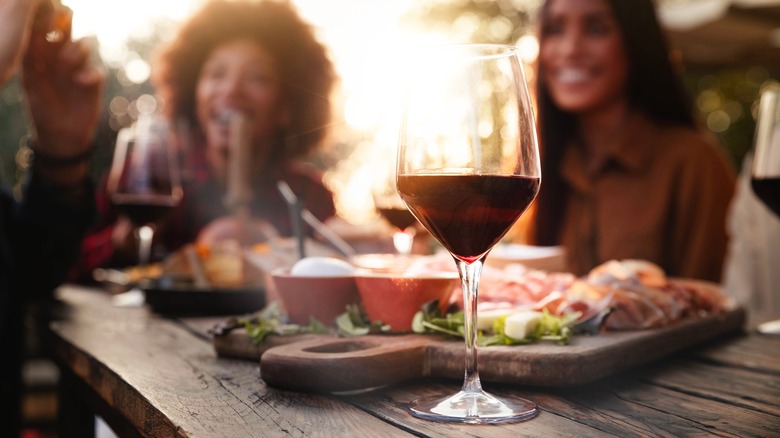 women with charcuterie and wine